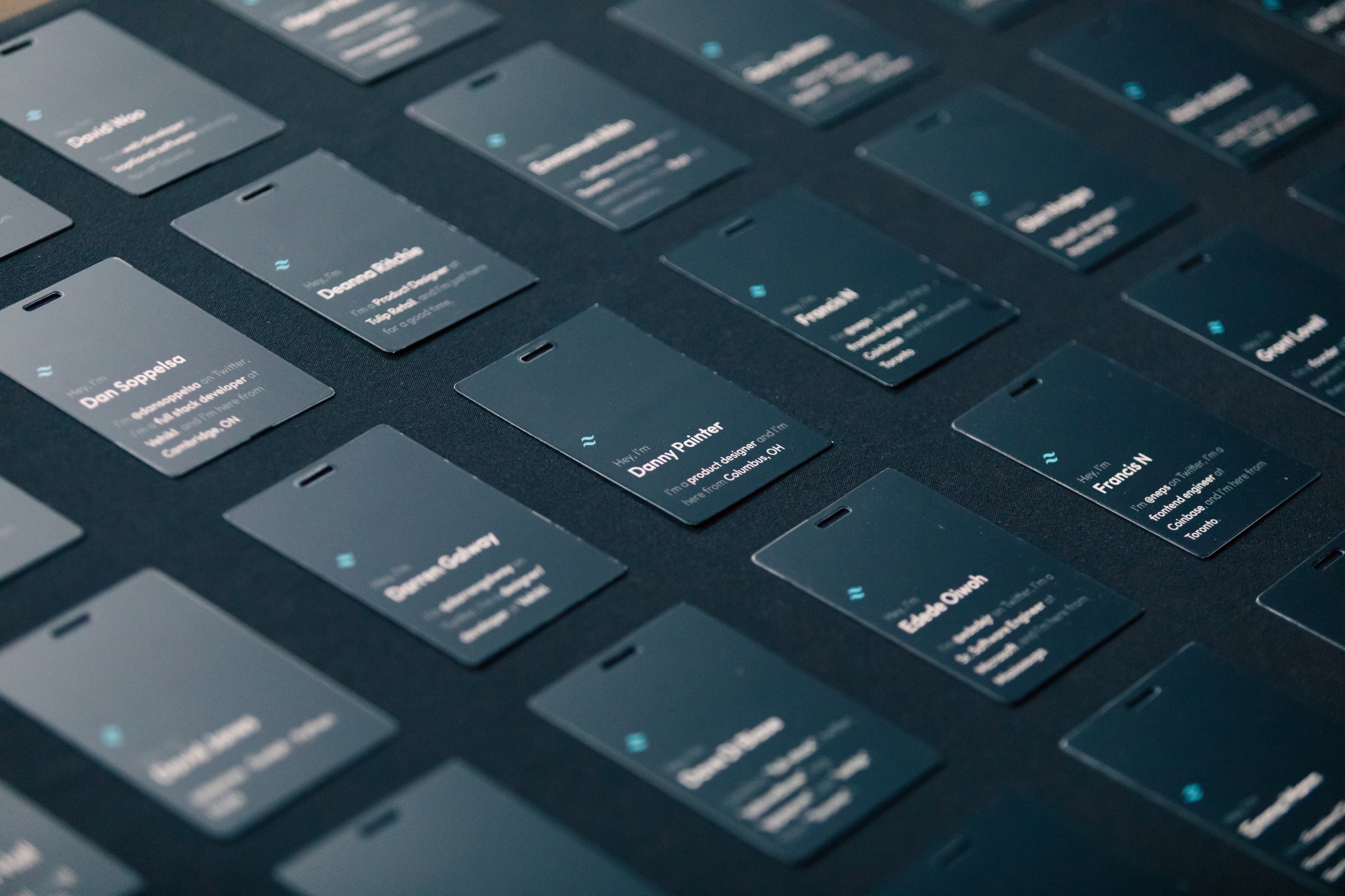 Attendee badges laid out on a table near the event entrance